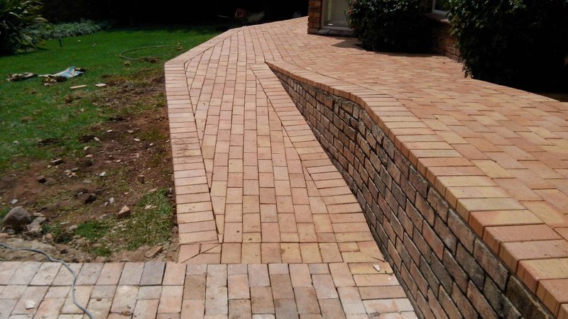 Curved Corobrick pathway with brick retaining wall in Alberton